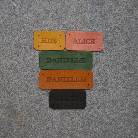 Colorful nameplates on a textured gray surface