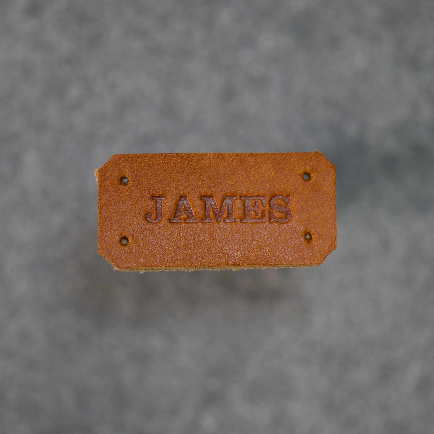 Close up image of James name tag in Golden Brown 
