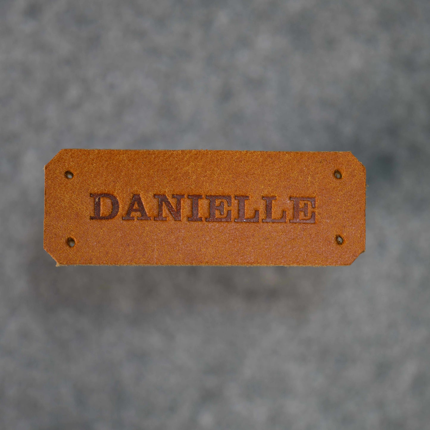Close up image of Danielle name tag in Golden Brown