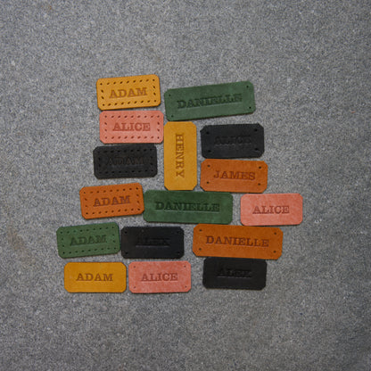 Colorful name tags on a gray surface