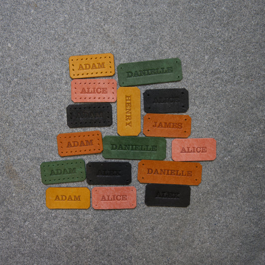 Colorful name tags on a gray surface