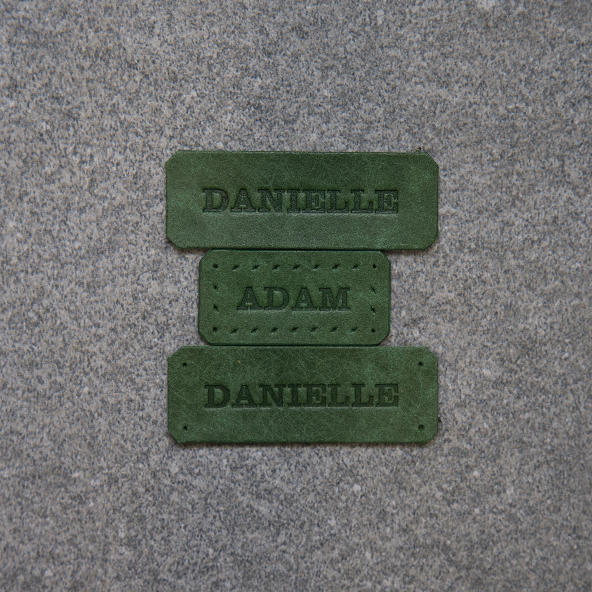 Close-up of a textured pink surface with a dark red logo or brand name.