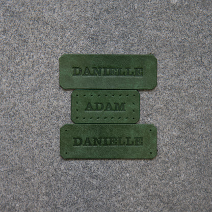 Close-up of a textured pink surface with a dark red logo or brand name.